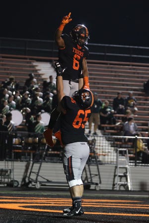 Massillon running back Terrence Keyes is lifted up by lineman John Kouth following a touchdown during the Week 5 win over Firestone.

(IndeOnline.com / Kevin Whitlock)