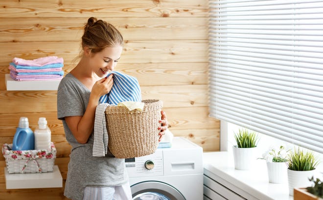 Natural light and decorations can help turn your laundry room into a space where you enjoy spending time. [Dreamstime]