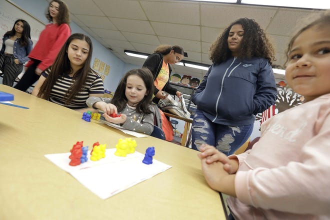 New Bedford High School seniors works with preschoolers in the New Bedfor High School day-care program for students involved in one of the many vocational programs availalble in the school. [ PETER PEREIRA/THE STANDARD-TIMES ]