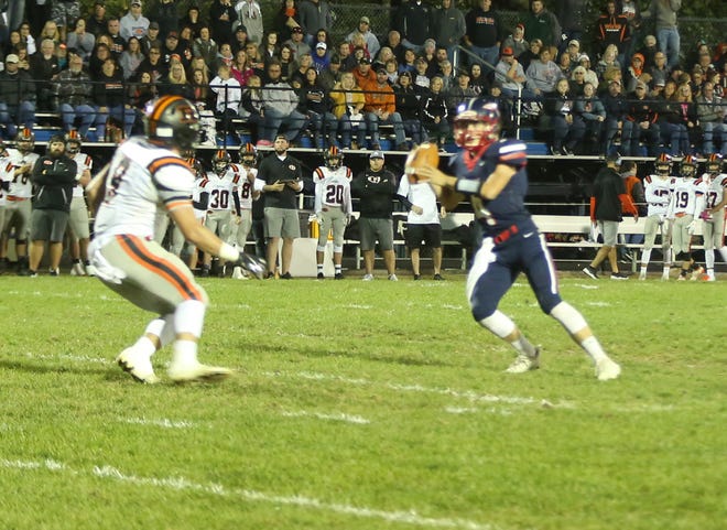 Ridgewood's Kaden Smith closes in on Indian Valley quarterback Ty Myers during Friday night's game at Kelley Field. (TimesReporter.com / Hank Keathley)