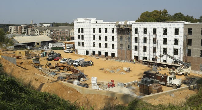 A new Comfort Inn and Suites under construction on Jack Warner Parkway east of the intersection with Greensboro Avenue is seen from Temerson Square as workers lay brick on the building's rear-facing side Thursday, Oct. 3, 2019. The hotel is expected to open in the spring. [Staff Photo/Gary Cosby Jr.]