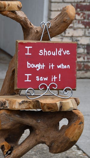 A sign on teakwood furniture encourages shoppers at the Fall Festival.

[PAUL CHURCH / THE COURIER-TRIBUNE]