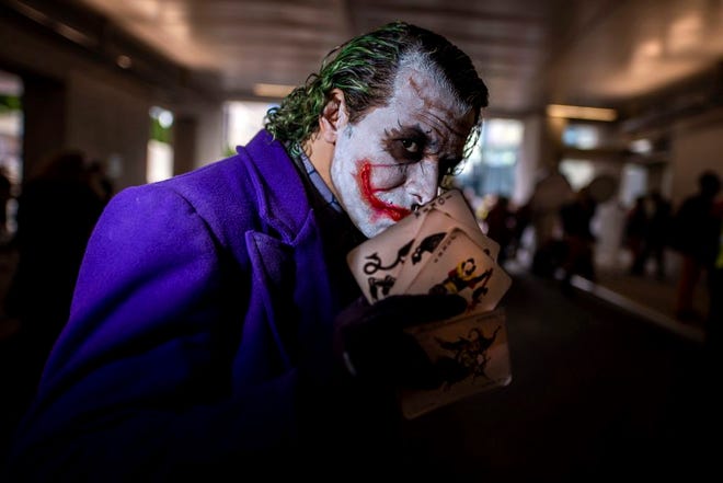 An attendee dressed as the Joker poses during New York Comic Con at the Jacob K. Javits Convention Center on Friday, Oct. 4, 2019, in New York. (Photo by Charles Sykes/Invision/AP)