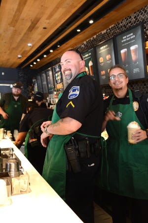 Savannah Police Officers Cpl. William Barnett and Mark Fleming worked behind the counter at Starbucks on Bay Street for a bit on Oct. 2 during the department's Coffee with a Cop. The talk sessions are for local police and the community to get to know each other. [DeAnn Komanecky/Savannahnow.com]