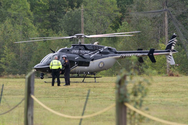 A helicopter belonging to the NC Highway Patrol lands at the staging area to pick up personnel to resume the search for a missing plane early Saturday morning. [Scott Pelkey / Special to The Courier-Tribune]