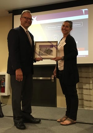 Mike Sanders, Monroe Clinic president & CEO and Fowler Dental Clinic board president, was recently honored with the Wisconsin Oral Health Coalition’s 2019 Warren LeMay Oral Health Champion Award. Pictured: Sanders receives the award from Tina Sopiwnik. [PHOTO PROVIDED]