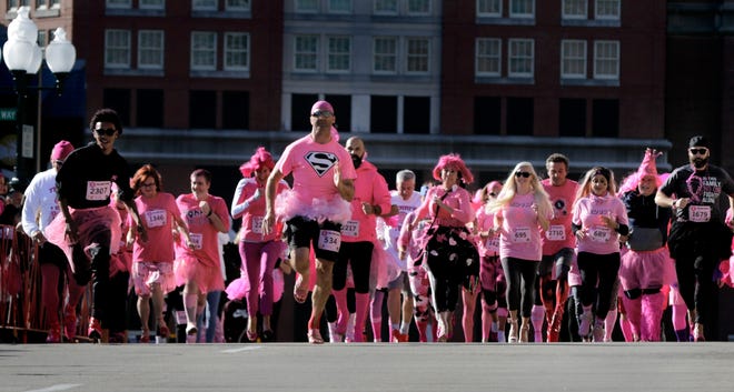 Men and women bolt off the starting line in high heels for the Pink Pump Palooza race Sunday morning, part of the Gloria Gemma Foundation run/walk series. [The Providence Journal / Kris Craig]