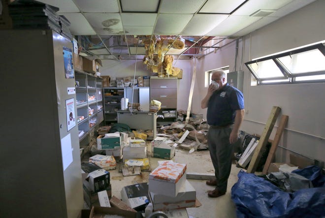 Technical Director of Naval Surface Warfare Center - Panama City Division Edwin A. Stewart walks through a heavily damaged building on Aug. 30 at NSA-PC. [PATTI BLAKE/THE NEWS HERALD]