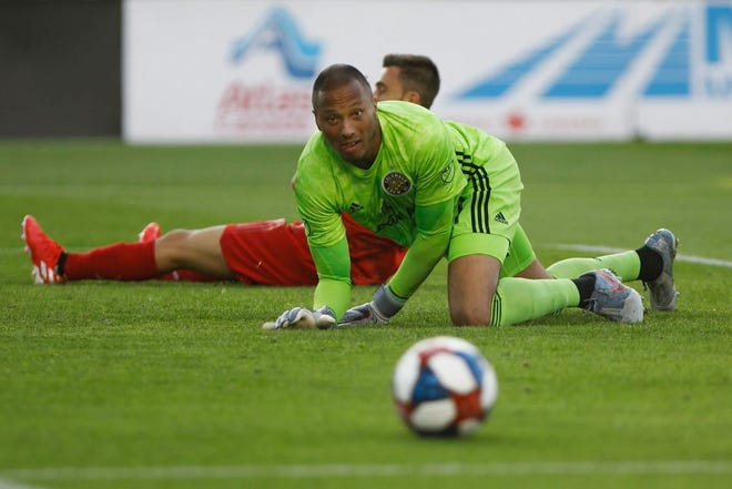 Columbus Crew SC goalkeeper Eloy Room watches the ball as it rolls away from the net after making a save during the second half of MLS soccer game action against Toronto FC in Toronto on Sunday. [Cole Burston/The Canadian Press via AP]