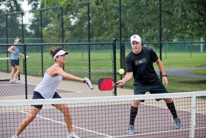 Anita and Jeff Cothern play pickleball at Hoff Woods Park.