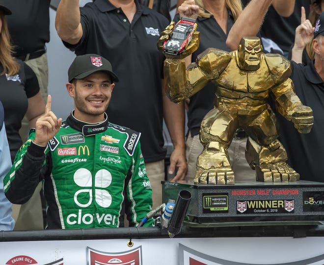 Kyle Larson stands next to the trophy after winning the NASCAR Cup Series race Sunday in Dover, Del. [AP Photo/Jason Minto]