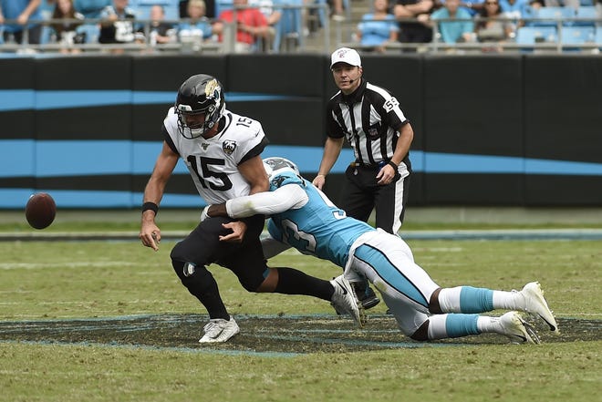 Carolina Panthers linebacker Brian Burns (53) tackles Jacksonville Jaguars quarterback Gardner Minshew (15) forcing a fumble during the second half of an NFL football game in Charlotte, N.C., Sunday, Oct. 6, 2019. (AP Photo/Mike McCarn)