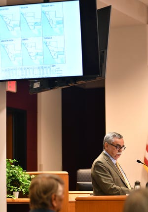 Kurt Spitzer, a consultant hired by Sarasota County to help with proposed redistricting, displays for the county commissioners several proposed redistricting maps submitted by members of the public. [Herald-Tribune staff photo / Mike Lang]