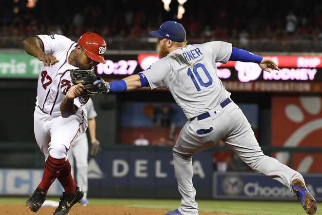 Washington Nationals Howie Kendrick (47) is tagged out by Los Angeles Dodgers third baseman Justin Turner (10) during the sixth inning in Game 3 of the National League Division Series on Sunday. [Susan Walsh/The Associated Press]