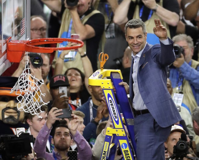 Virginia coach Tony Bennett cuts down the net after his Cavaliers won the NCAA Championship game 85-77 in overtime against Texas Tech. Virginia finished with a 16-2 mark in the ACC last season to share conference honors with UNC, [AP Photo/Matt York]