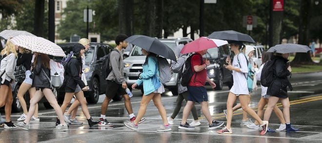 A passing band of showers brought some much-needed rain to West Alabama Monday, Oct. 7, 2019. Students crossing University Boulevard on the University of Alabama campus wear their rain gear as they move between classes. [Staff Photo/Gary Cosby Jr.]