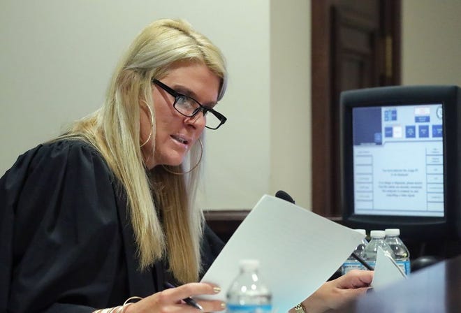 Judge Amy Corrigall Jones looks over documents during a hearing Monday for Alice Jenkins at the Summit County Courthouse in Akron. [Jeff Lange/Akron Beacon Journal]
