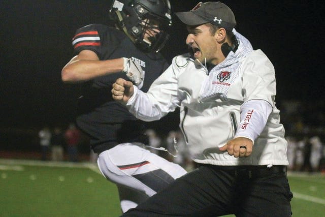 ADM sophomore Lucas Ray and head coach Garrison Carter celebrating after a score against Creston Friday, Oct. 4 in Adel. PHOTO BY ANDREW BROWN/DALLAS COUNTY NEWS