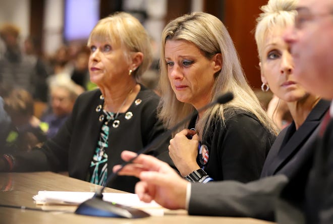 Cindy Chesna, widow of Weymouth police Sgt. Michael Chesna, teared up Tuesday during testimony from her mother-in-law Maryann (left) and Reps. Shaunna O'Connell and David DeCoste. [Photo: Sam Doran/SHNS]