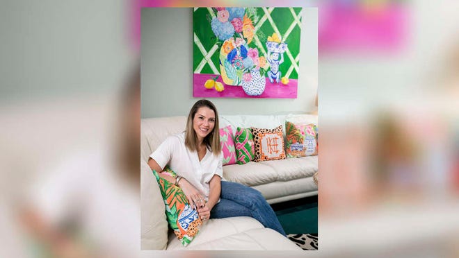 Artist Katie Herman sits with some of her pieces inside her home in Tequesta on Monday October 7, 2019. [RICHARD GRAULICH/palmbeachpost.com]