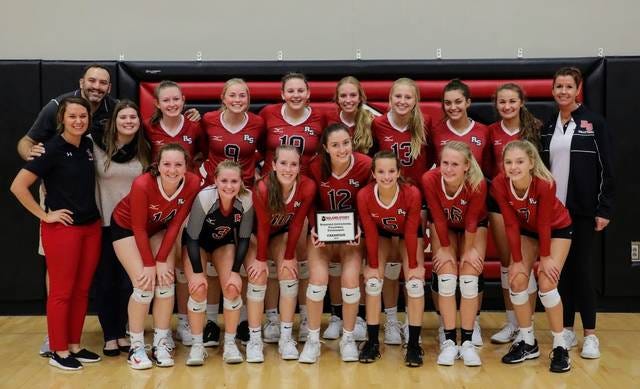 The Roland-Story volleyball players and coaches pose with their championship plaque after winning the Norsemen Invitational Sept. 30 in Story City. Photo by Peg Patterson.