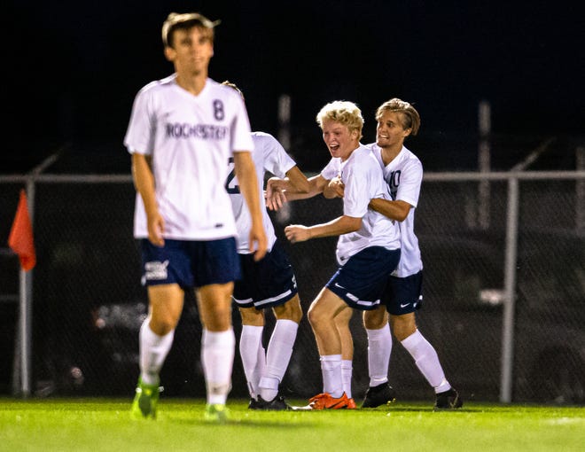Rochester High School's Jack Hart (15) celebrates a goal with his teammates that put the Rockets up 2-1 over Springfield High in the second half at Lee Field, Tuesday. [Justin L. Fowler/The State Journal-Register]
