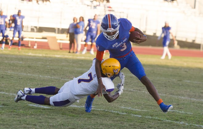 Robert Cummings of Benedict, left, makes a diving tackle on Savannah State's D'vonn Gibbons at the Augusta Classic football game between Savannah State and Benedict College in Augusta, GA, Saturday, September 21, 2019. [MIKE ADAMS/SPECIAL]