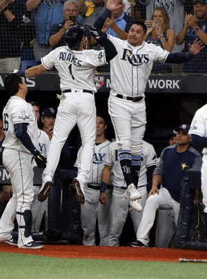 Tampa Bay Rays' Willy Adames celebrates his solo home run against the Houston Astros with Avisail Garcia, right, in the fourth inning of Game 4 of Tuesday's American League Division Series. Tampa Bay won to force a deciding fifth game Thursday in Houston. [Scott Audette/The Associated Press]