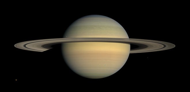This July 23, 2008 file image made available by NASA shows the planet Saturn, as seen from the Cassini spacecraft. Twenty new moons have been found around Saturn, giving the ringed planet a total of 82, scientists said Oct. 7.  (NASA/JPL/Space Science Institute via AP, File)