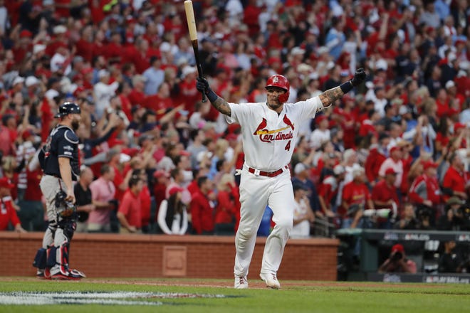 Yadier Molina celebrates after hitting a sacrifice fly in the bottom of the 10th inning to score Kolten Wong as the Cardinals defeated the Atlanta Braves in Game 4 of the National League Division Series on Monday in St. Louis. The Cardinals won 5-4. [AP Photo/Jeff Roberson]