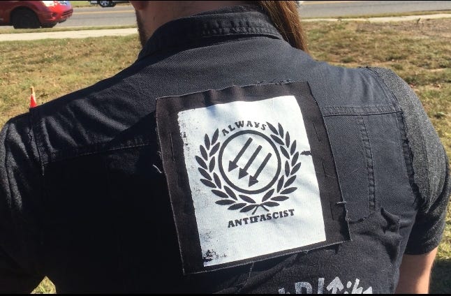 Kevin French, of Brick, New Jersey, attends the South Jersey Pagan Pride Day wearing an anti-fascist jacket. [JAMES McGINNIS / STAFF PHOTOJOURNALIST]
