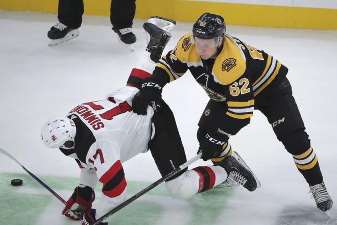 The Bruins' Oskar Stee knocks the Devils' Wayne Simmonds to the ice during the preseason. [CHARLES KRUPA / ASSOCIATED PRESS]