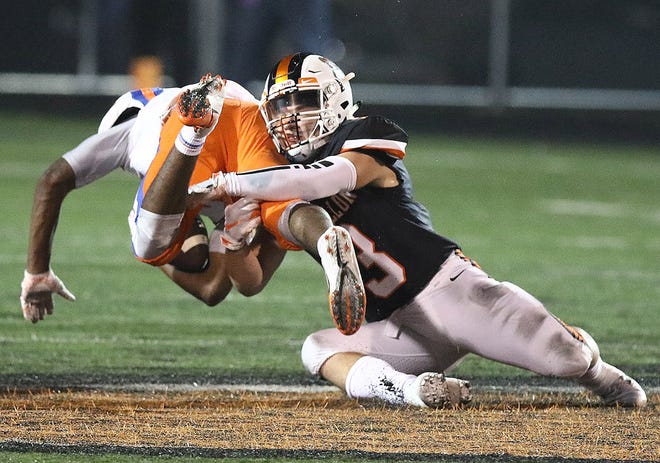 Massillon's Preston Hodges brings down East St. Louis' Treven Swingler during last year's 2018 Week 7 Tigers win.

(IndeOnline.com / Kevin Whitlock)