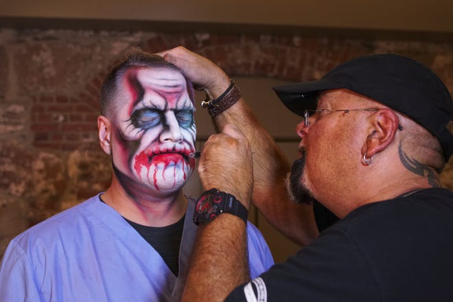 Preparing for the Fortress of Nightmares, actor Walter Kay has his face airbrushed by Jef Benson in 2018. (Peter Silvia Photo)
