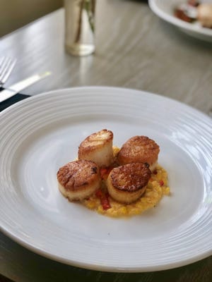 Chef Joseph Thompson serves up seared scallops at One Bellevue. [PHOTO CONTRIBUTED BY HOTEL VIKING]