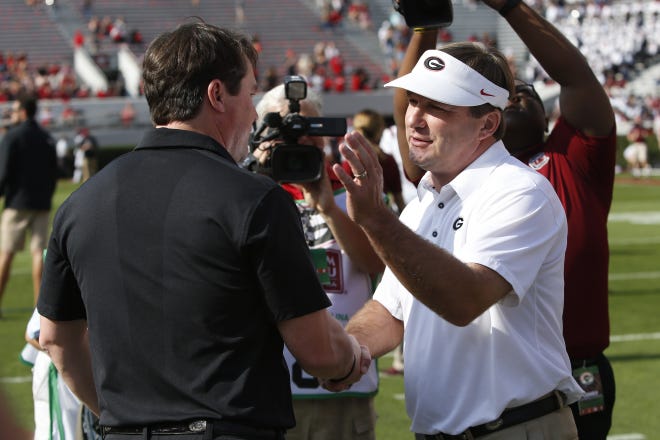 South Carolina coach Will Muschamp shakes hands with Georgia head coach Kirby Smart before the start of a game in 2017. (Photo/Joshua L. Jones, Athens Banner-Herald)