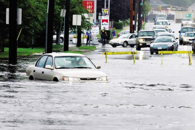 Will this scene from 2008 be repeated in the coming days? This unfortunate motorist was caught in a flooded Route 6 in New Bedford. [STANDARD-TIMES FILE]