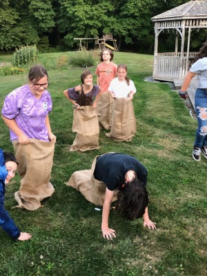 Children from the First Parish Brewster Unitarian Universalist Church practice for sack races planned for the first Brewster Potato Fest. [TWINKS HASTINGS]