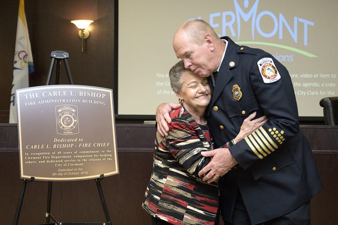 Clermont Mayor Gail Ash thanks Fire Chief Carle Bishop for his service at a City Council meeting on Tuesday. [Cindy Sharp/Correspondent]