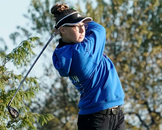 Lenawee Christian's Lauren Swiggum watches a shot during the Division 4 regional regional competition at Devils Lake Golf Course in Manitou Beach. Swiggum finished third individually with a 95, while the Cougars finished second as a team with a 420, in the team's first season of competition.