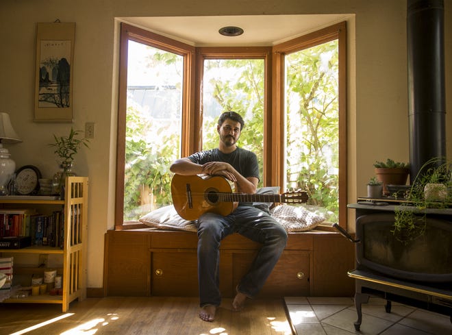 Musician Girin Guha in his home in Eugene. [Dana Sparks/The Register-Guard] - registerguard.com