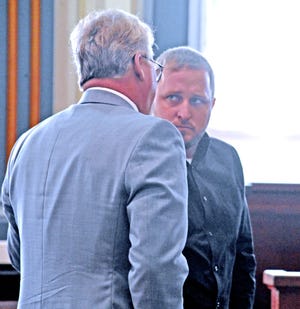 Jeriah Mast confers with his lawyer John Johnson Jr. after his pre-trial hearing in Millersburg on Wednesday. (GateHouse Media Ohio, Mike Schenk, The Daily Record)