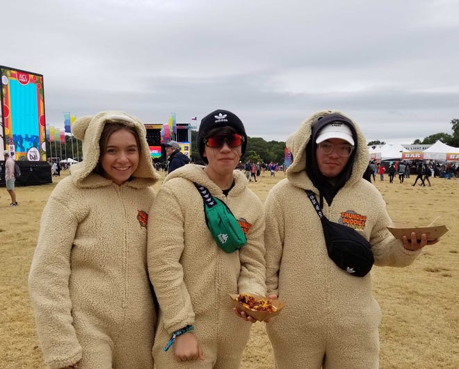 Daryn Davis, Drew Permenter and Arturo Rodriguez sport matching onesies to stay warm at ACL Fest 2019.
