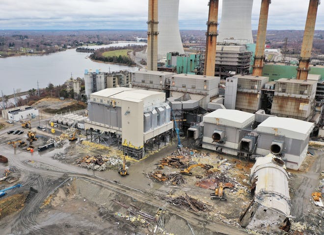 Workers dismantle parts of the former coal-fired power plant at Brayton Point before the April demolition of the property's cooling towers. [Herald News File Photo]