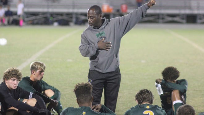White Oak soccer coach Buddy Carroll talks to his team during halftime of the Vikings' 2-1 win over Swansboro on Thursday. [Chris Miller / The Daily News]