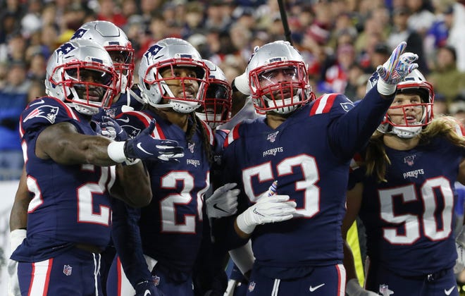 Kyle Van Noy (53) and teammates watch the replay of his fumble return for a touchdown in the fourth quarter. [The Providence Journal / Bob Breidenbach]