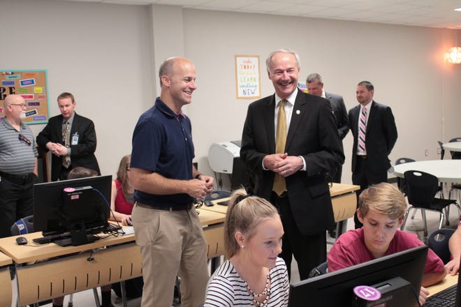 Former state Sen. Jake Files, left, is seen in August 2016 with Gov. Asa Hutchinson during a tour of Greenwood High School. Files, 47, was charged in June 2018 with money laundering and fraud and sentenced to 18 months in federal prison. He was recently transferred from El Reno Federal Correctional Institute in Oklahoma to a halfway house in Grand Prarie, Texas, after serving most of his sentence. [TIMES RECORD FILE PHOTO]