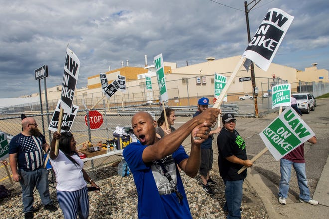 Flint resident Jashanti Walker, who has been a first shift team leader in the body shop for two years, demonstrates with more than a dozen other General Motors employees outside of the Flint Assembly Plant on Sunday, Sept. 15, 2019, in Flint, Mich. The United Auto Workers union says its contract negotiations with GM have broken down and its members will go on strike just before midnight on Sunday. (Jake May/The Flint Journal via AP)