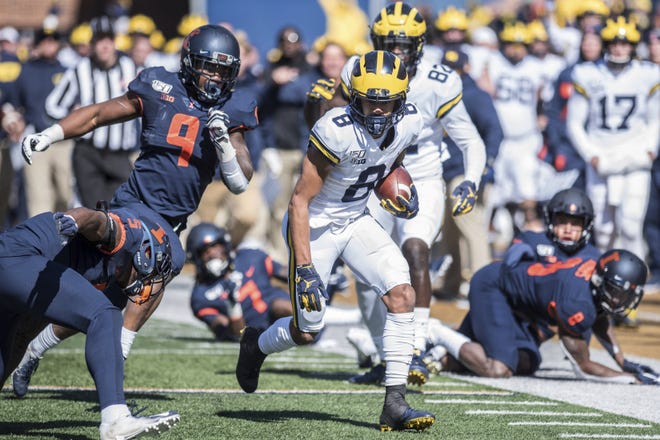 Michigan's Ronnie Bell (8) run after a pass reception in the first half of an NCAA college football game against Illinois, Saturday, Oct. 12, 2019, in Champaign, Ill. (AP Photo/Holly Hart)