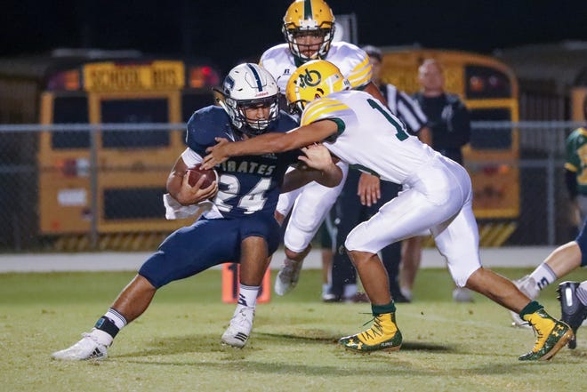 Swansboro's Isaac Wooten tries to elude a defender during the Pirates' 44-0 win over White Oak on Friday. [Tina Brooks / The Daily News]